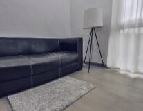 couch, indoor, floor, wall, sofa bed, studio couch, bed, room, pillow, coffee table, loveseat, chair